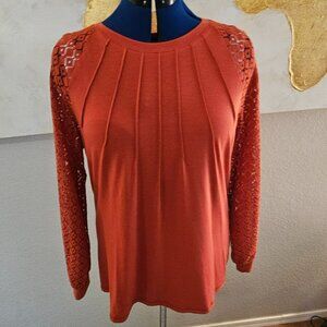 Orange long sleeve top with crochet arms